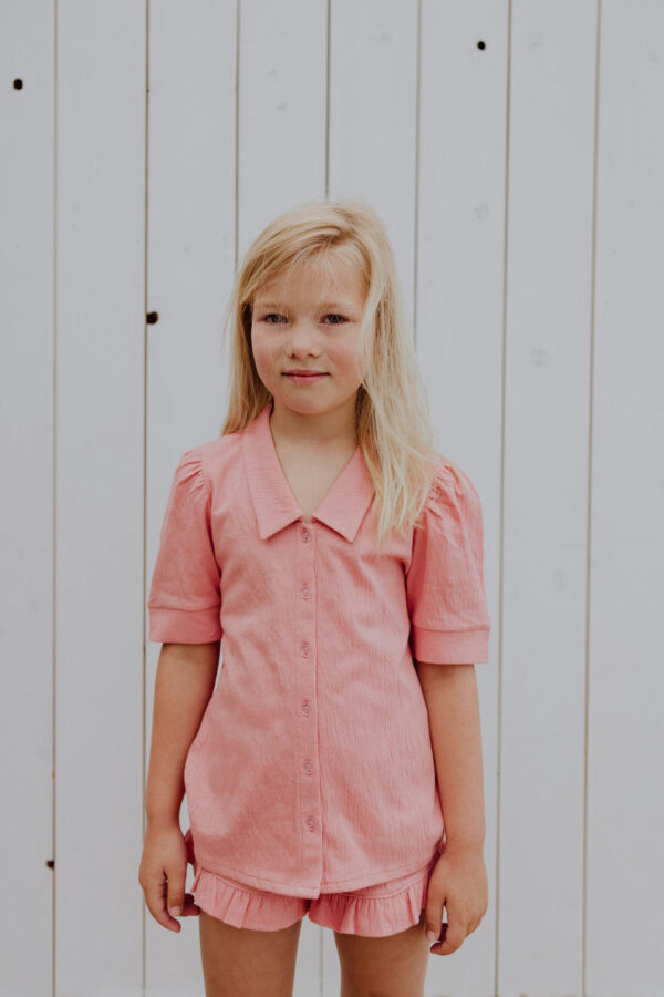 Little Hedonist puff sleeve blouse in Coral Almond for girls. This button down shirt is made from organic cotton. Sustainable kids clothing.