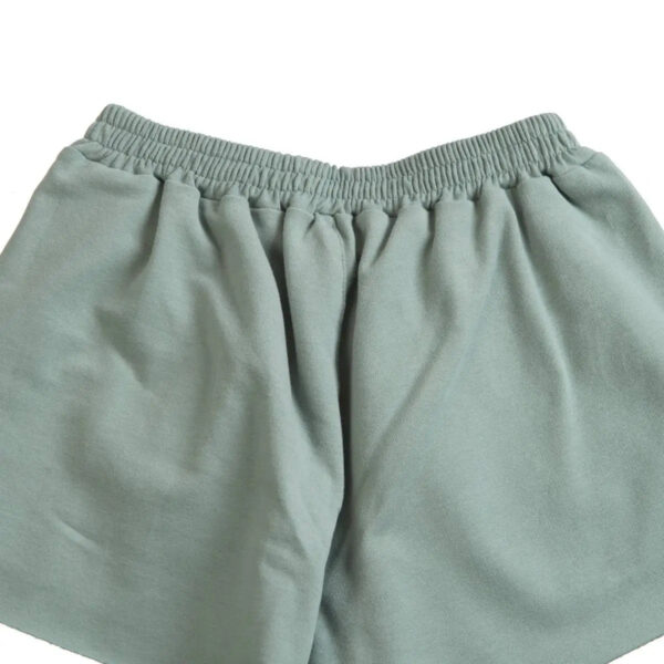 Little Hedonist organic pleated shorts with flowing cut and hidden pockets in Chinois Green. Sustainable fashion for kids.